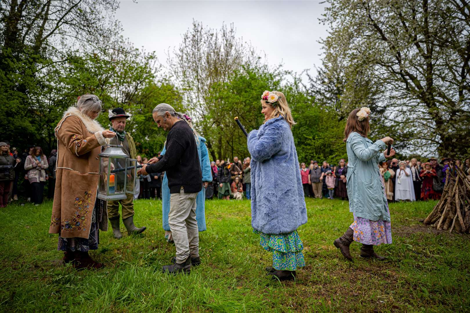 A candle flame is used to light the Beltane bonfire at Chalice Well, Glastonbury (Ben Birchall/PA)