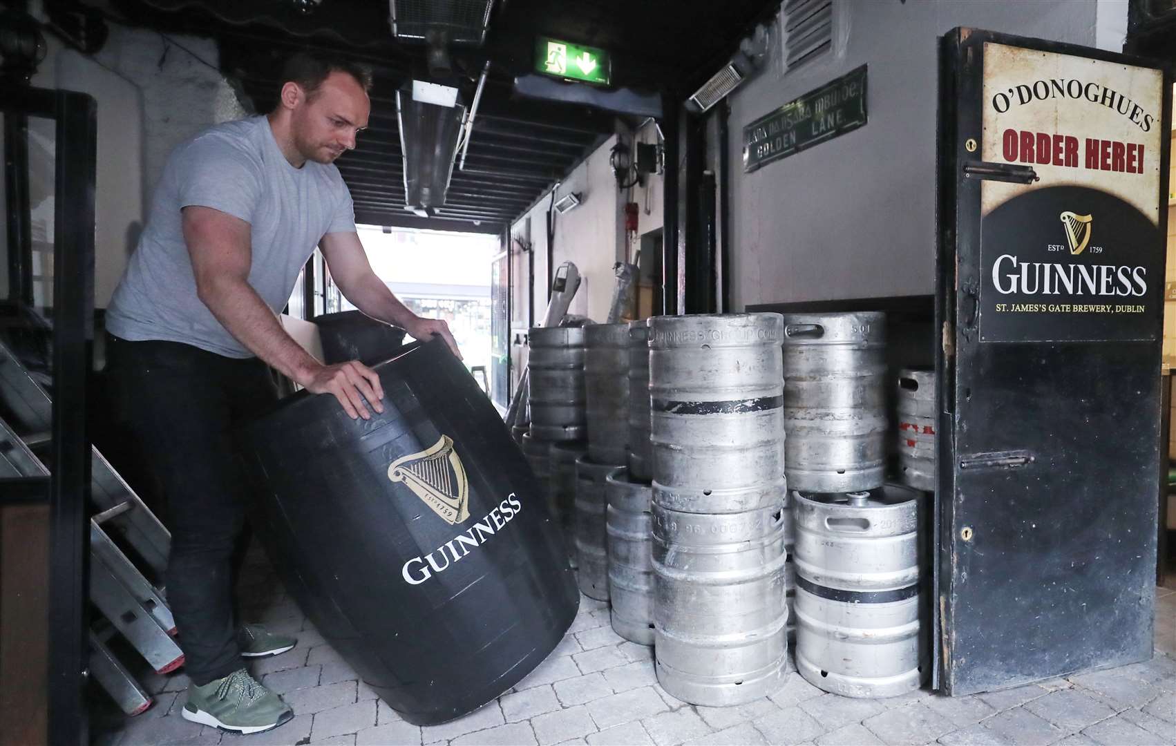 Kevin Barden sets up an outdoor drinking area at O’Donoghues Bar in Dublin (Niall Carson/PA)