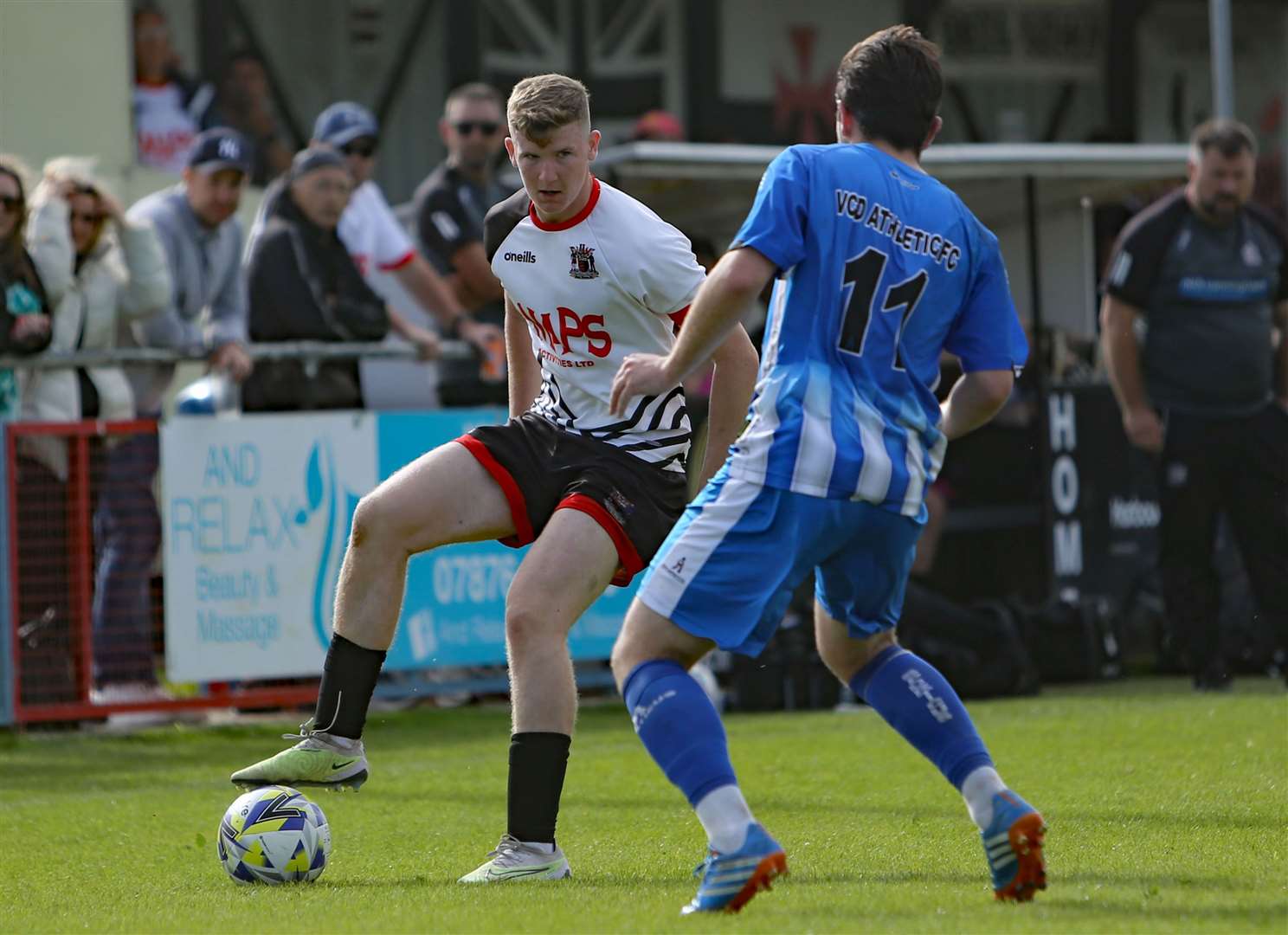 Elliott Moore, of Deal Town, on the ball as boss Steve King watches on during their weekend 2-0 home loss to VCD. Picture: Paul Willmott