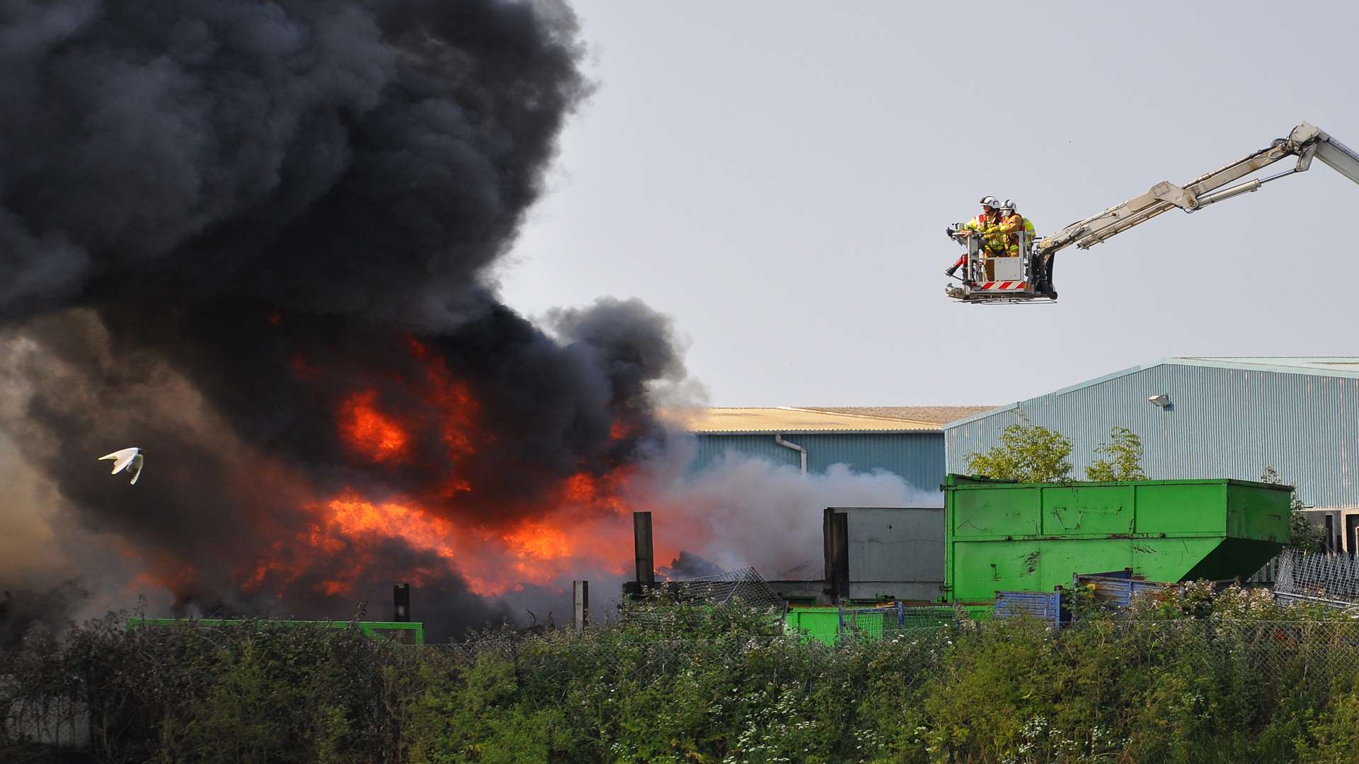 Firefighters use an aerial appliance to tackle the flames from above last night. Picture: Andy Ives