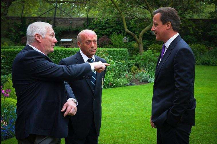 Greenhithe Legion Centenary Poppy Campaign coordinator Graham Mentor-Morris, joined by chairman, Phil Berry explains the finer points of poppy planting to the PM