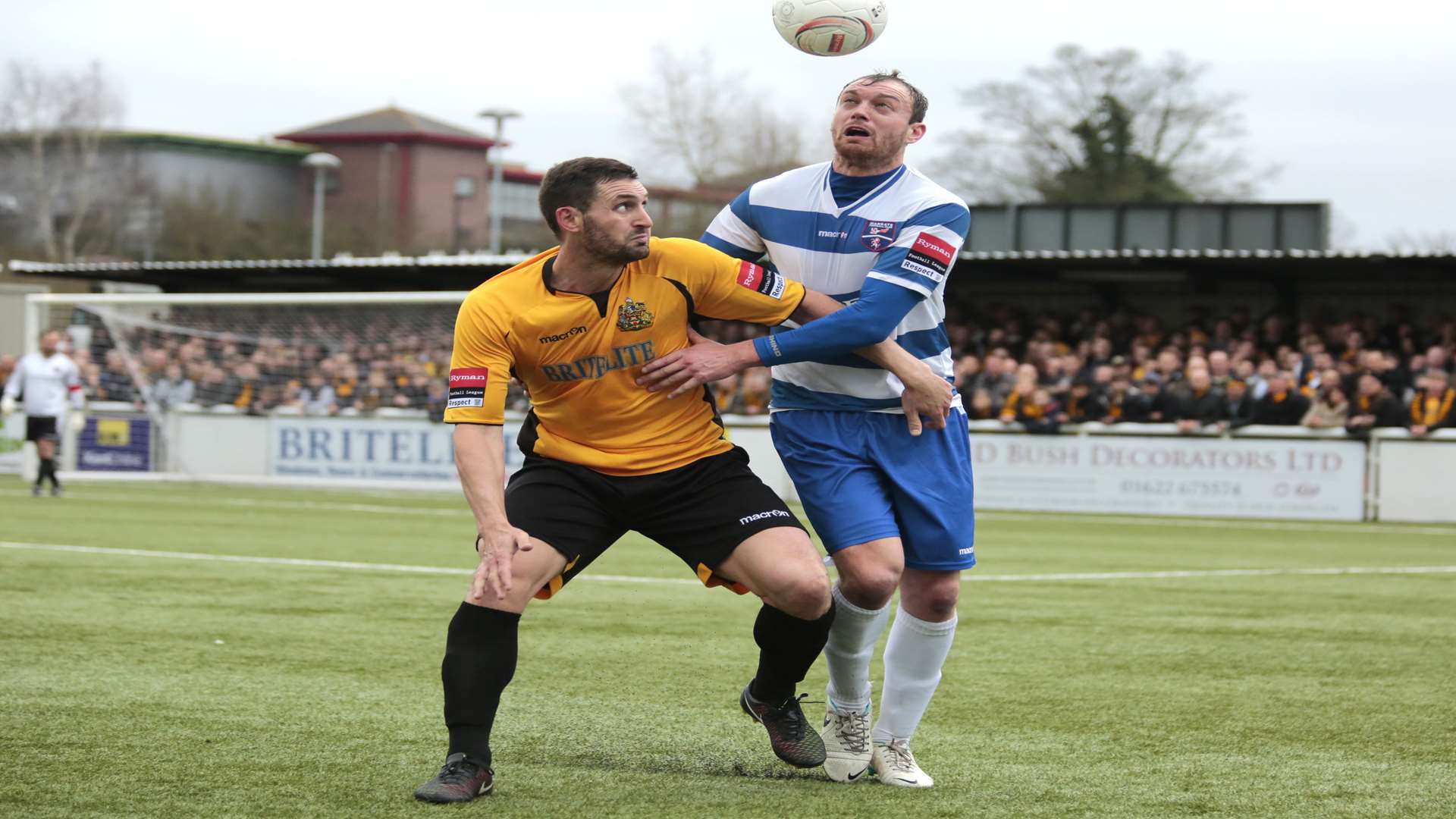 Brett Johnson up against Maidstone's Jay May last season Picture: Martin Apps