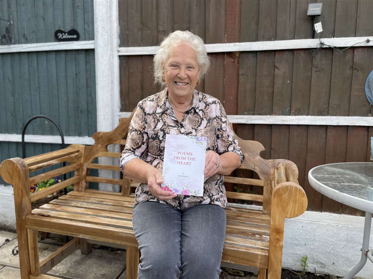 Delia Redsell with a book of poetry she wrote while caring for her late husband William