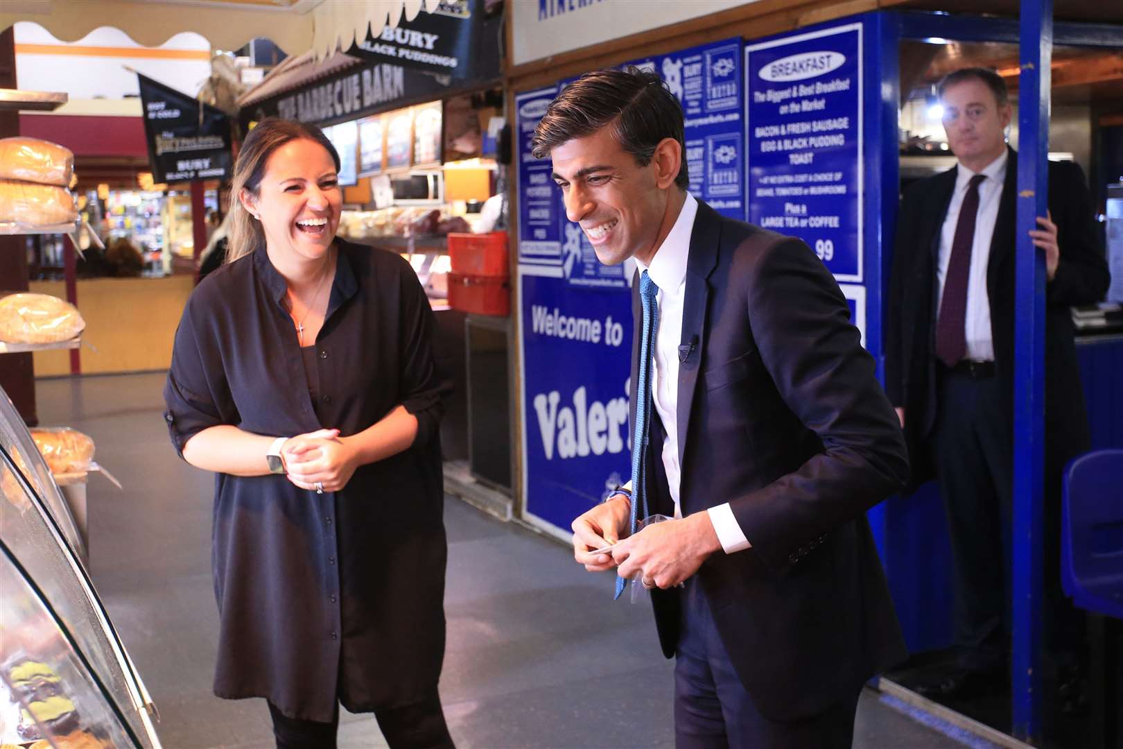 Chancellor of the Exchequer Rishi Sunak laughs during a tour of the Bury Market in Lancashire, the day after presenting his budget to the House of Commons (Lindsay Parnaby/PA)