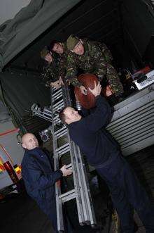 Loading an army truck with equipment