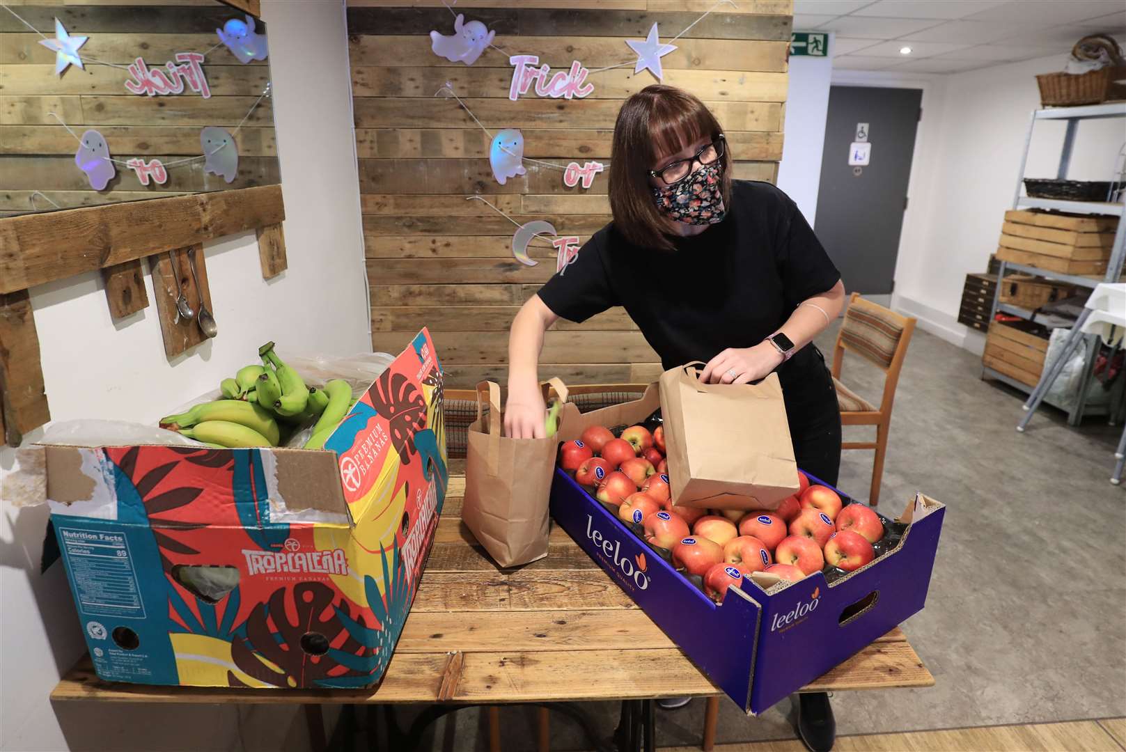 Dawn Grain, manager of the Rumour Cafe, prepares bags containing free meals. Owner Paul West said they wanted to take a little of the pressure off parents (Gareth Fuller/PA)