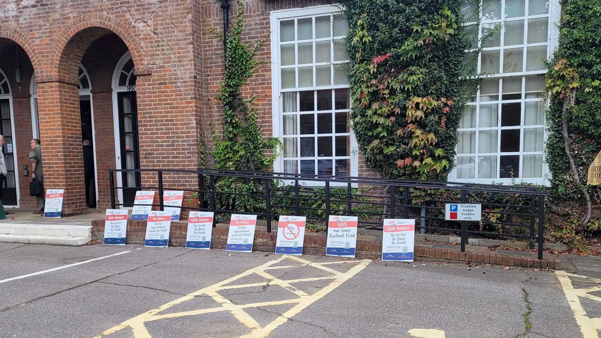 Those attending the hearings last week were greeted with a row of placards from protesters