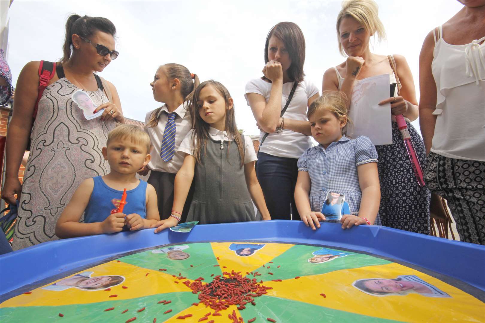 Sid, three, Annie, seven and Molly, five, enjoy the maggot racing