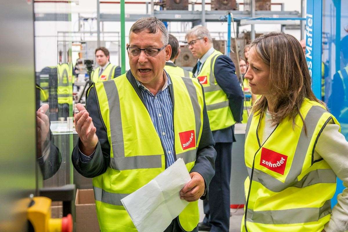 The MP is given a tour of the plant by Conrad Thrower