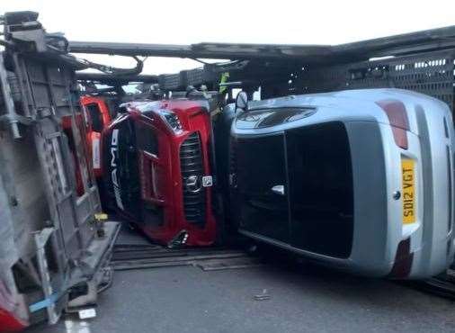 Luxury car have been damaged after a car transporter overturned. Picture: Ben Slipper