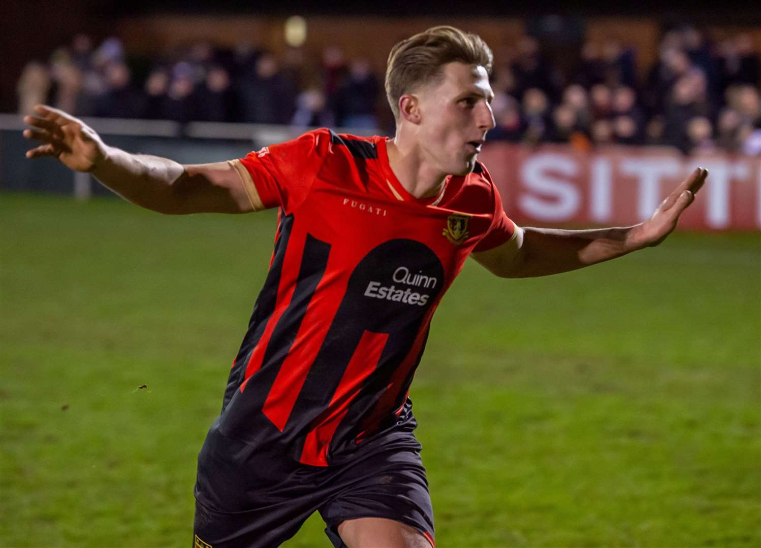 Sittingbourne right-back Liam Smith helped to get the floodlights going for the second half. Picture: Ian Scammell