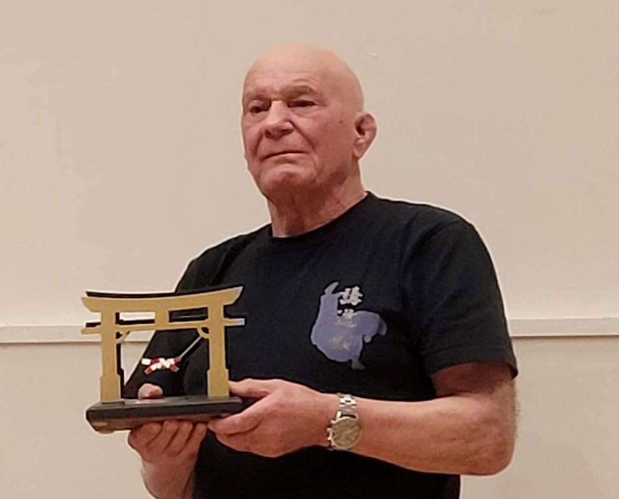 Trevor Davies with the shield he was presented with to mark his 65 years in the sport