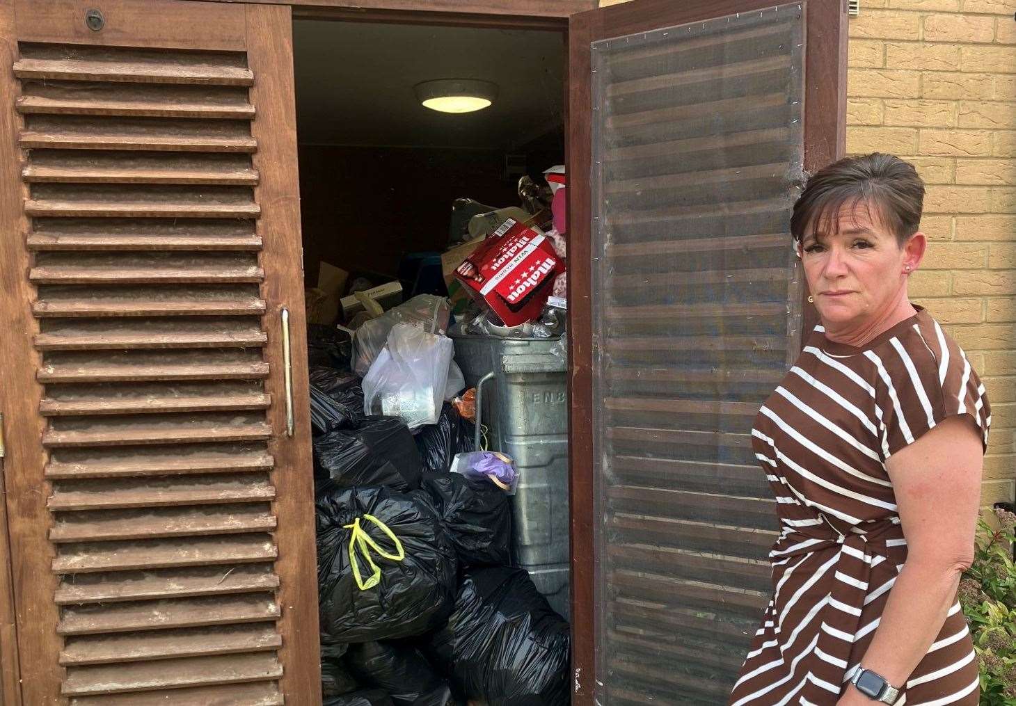 Sarah Barnes with the rubbish by her daughter's flat at Hedley Walk, Church Street, in Sittingbourne. Picture: Sarah Barnes