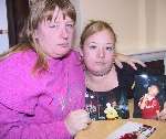 Tobi's mother Sam (right) and grandmother Tracy with pictures of the little boy