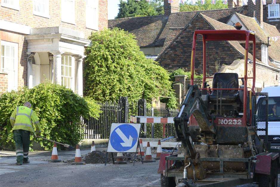 Workmen clear up after the mains burst