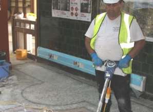 Specialist Carlos Cedeno working on the mosaic floor at the Dartford Library