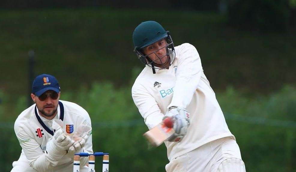 Jamie Hemphrey swings hard ahead of Sandwich wicketkeeper Ryan Davies. Picture: Gary Restall