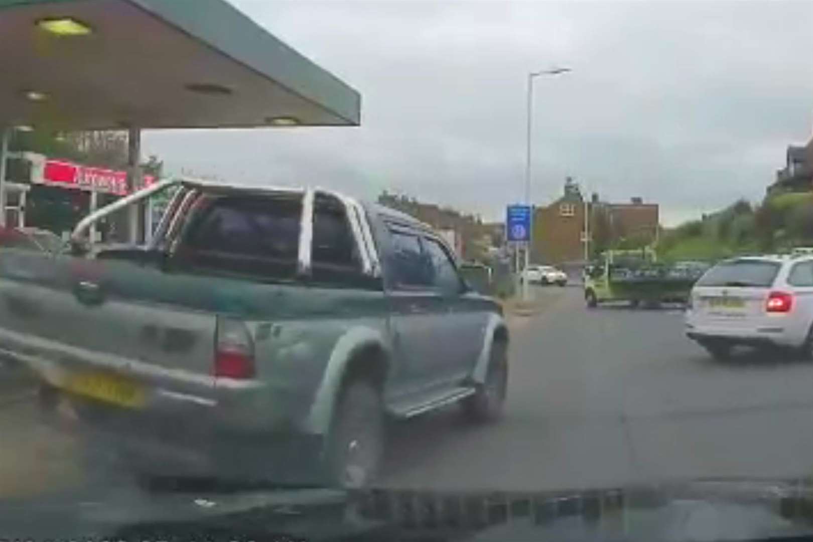 The driver mounted the kerb by the car dealership