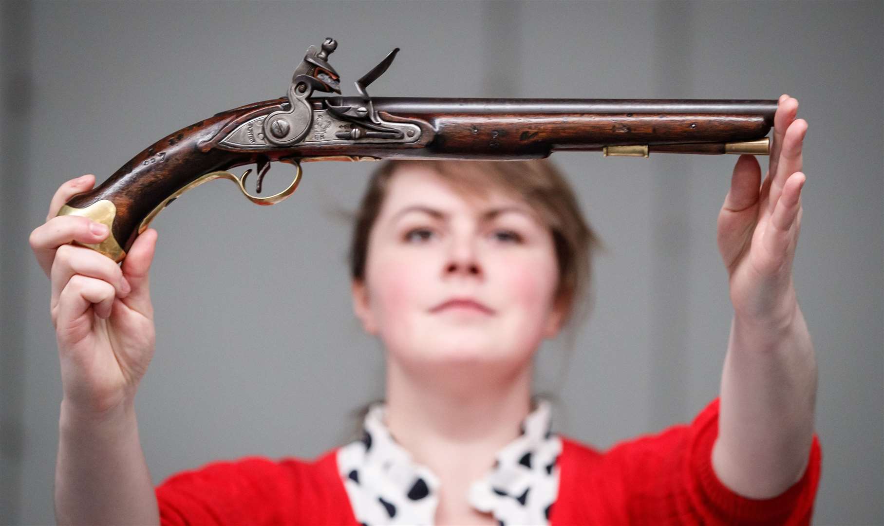 Tennants Auctioneers’ employee Alice Fitton holds a flintlock pistol once owned by William Rivers, who served on board HMS Victory during the Battle of Trafalgar (Danny Lawson/PA)