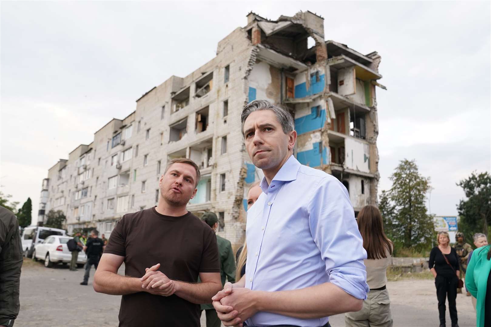 Taoiseach Simon Harris speaks to head of the Kyiv state regional administration, Ruslan Kravchenko, during a visit to inspect damage to buildings in Borodyanka (Stefan Rousseau/PA)