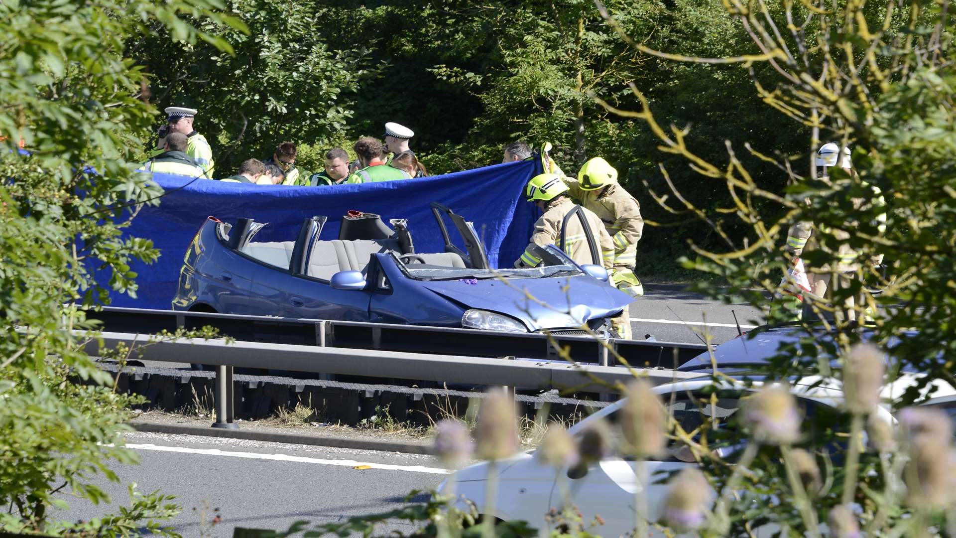 Emergency services shield accident from view