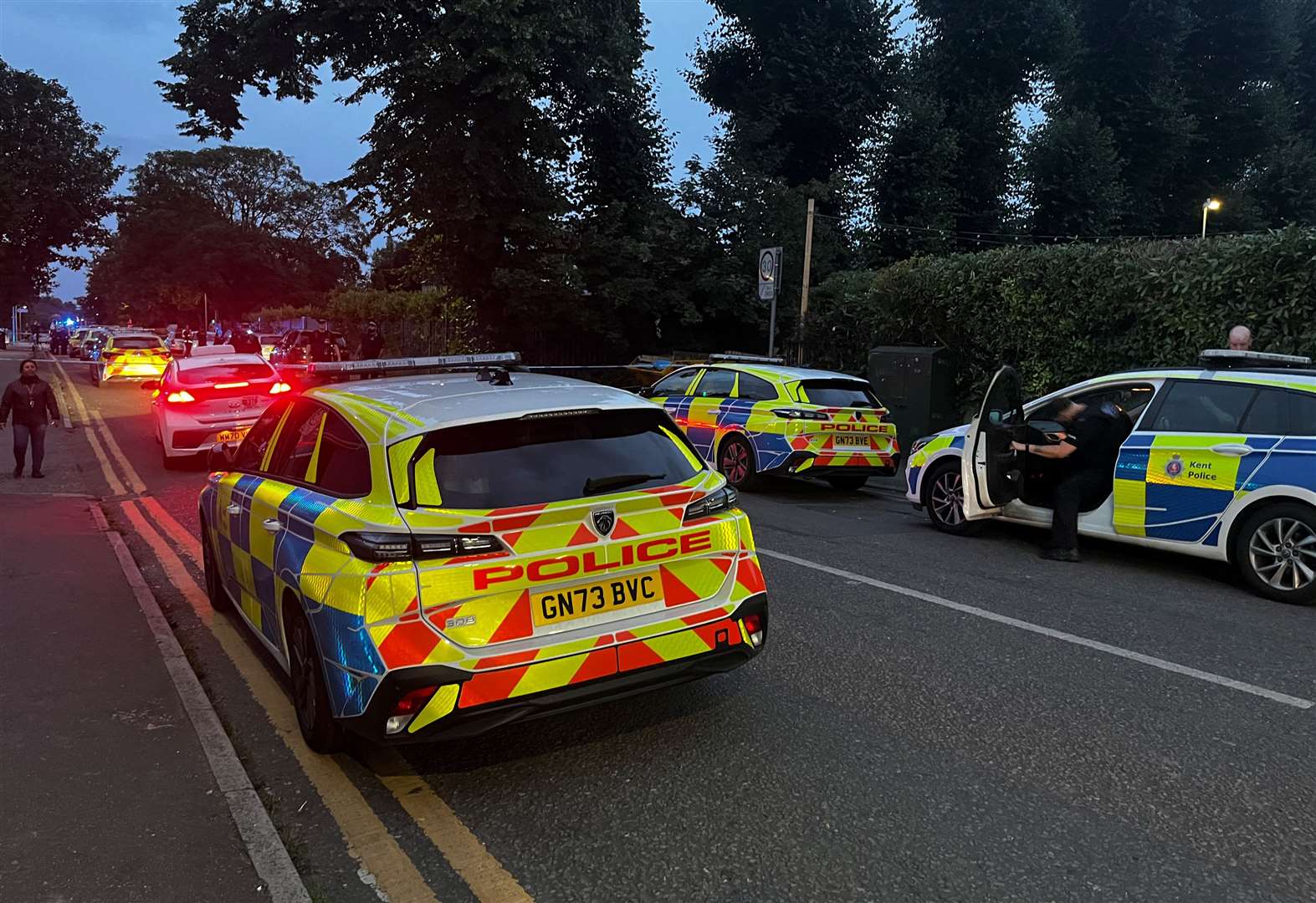 Police cars line the street in Gravesend near the gurdwara