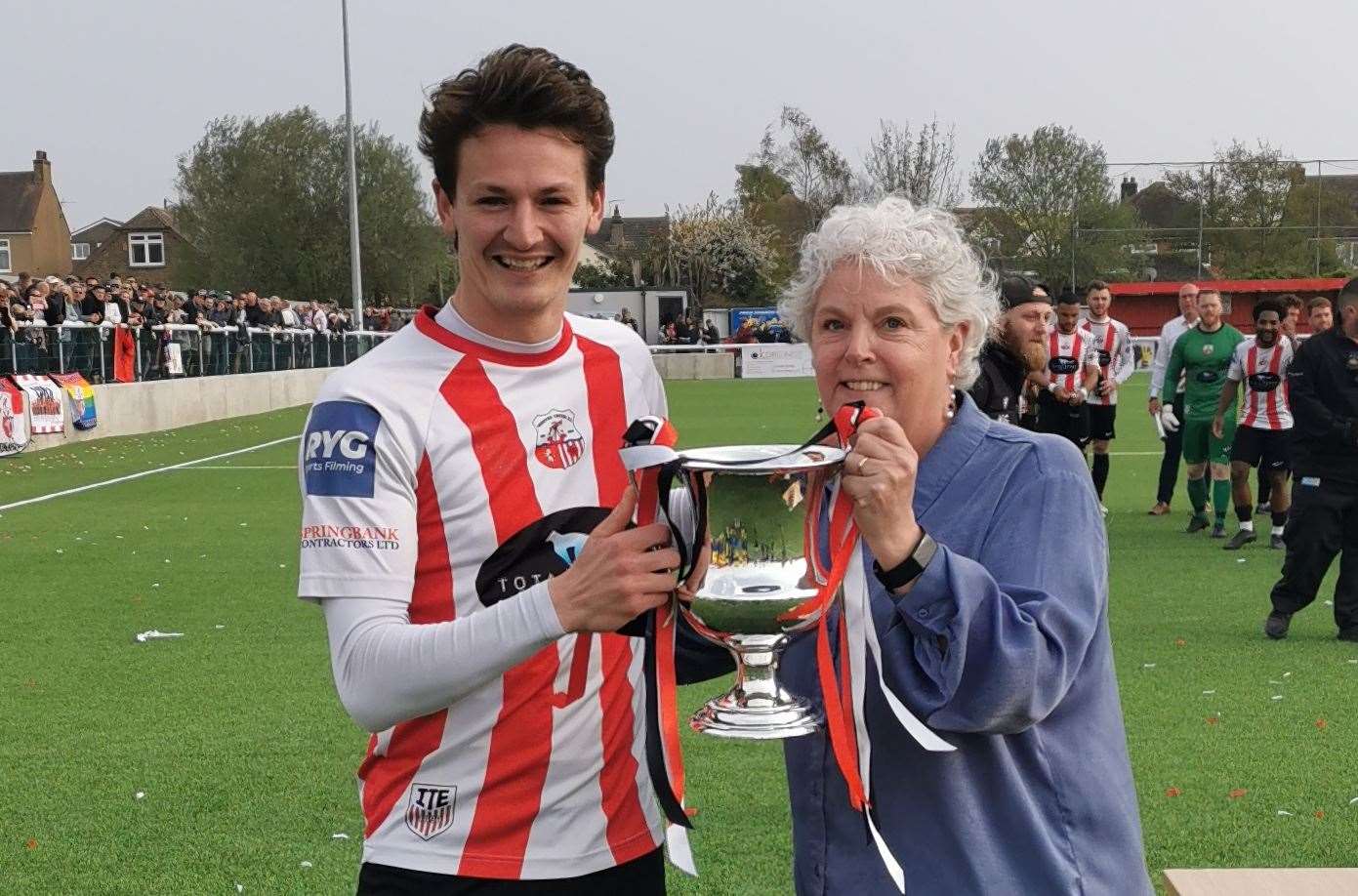 Southern Counties East chair Denise Richmond presents Sheppey captain Billy Bennett with the Southern Counties East League Premier Division trophy.