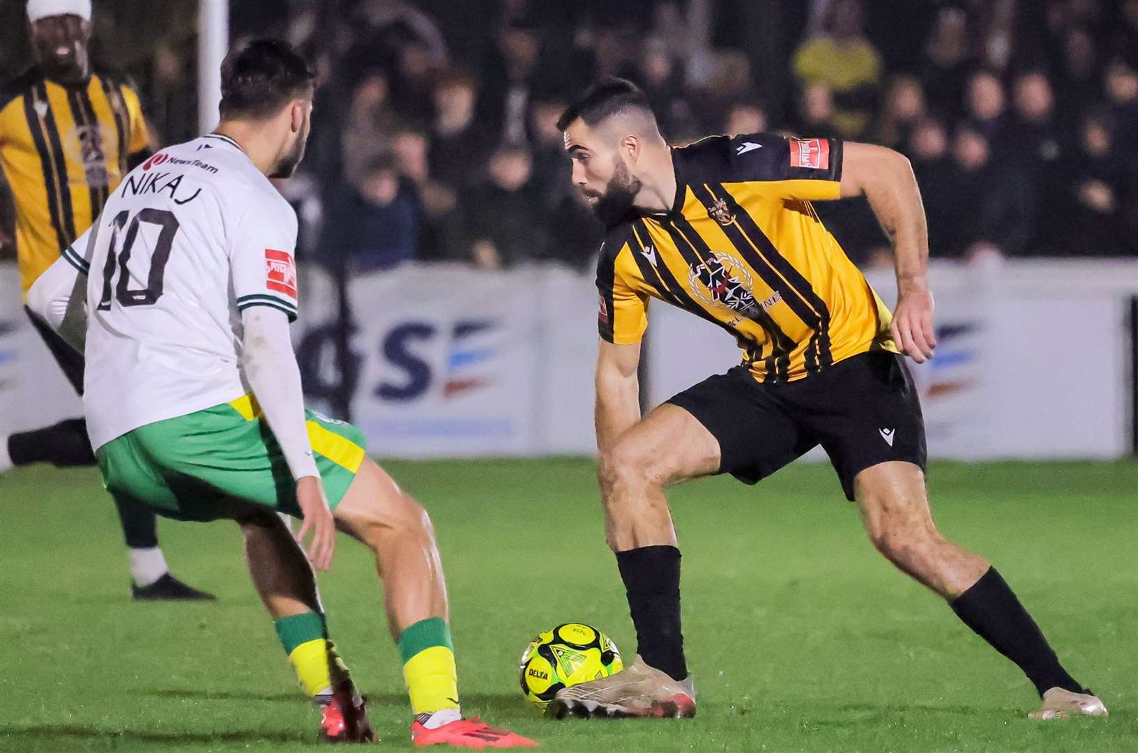 Substitute Joe Turner takes on Dover's top scorer George Nikaj on his home Folkestone Invicta debut. Picture: Helen Cooper