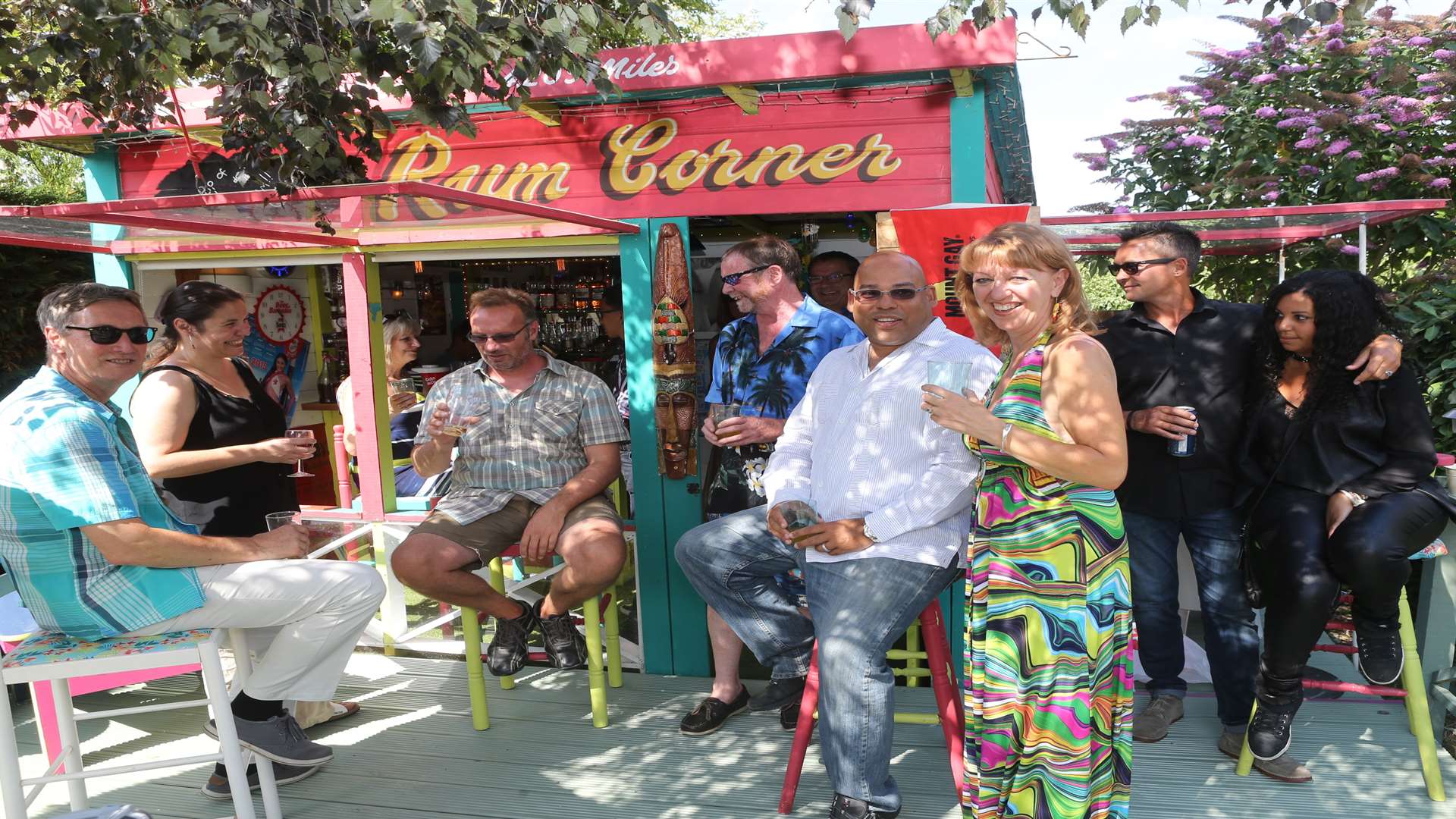 Guy Hewitt, the High Commissioner, centre, for Barbados with Nick and Debbie Siminson and guests at their home, where they had a garden shed decked out as a Bajan-style bar.