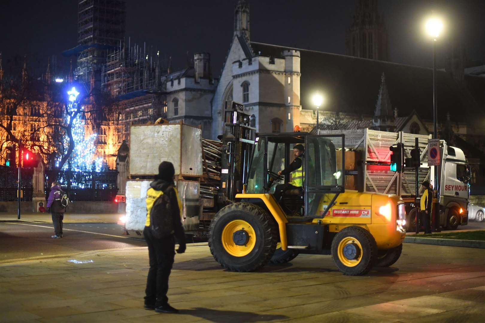 Construction workers put up fencing around the statues in Parliament Square (Victoria Jones/PA)