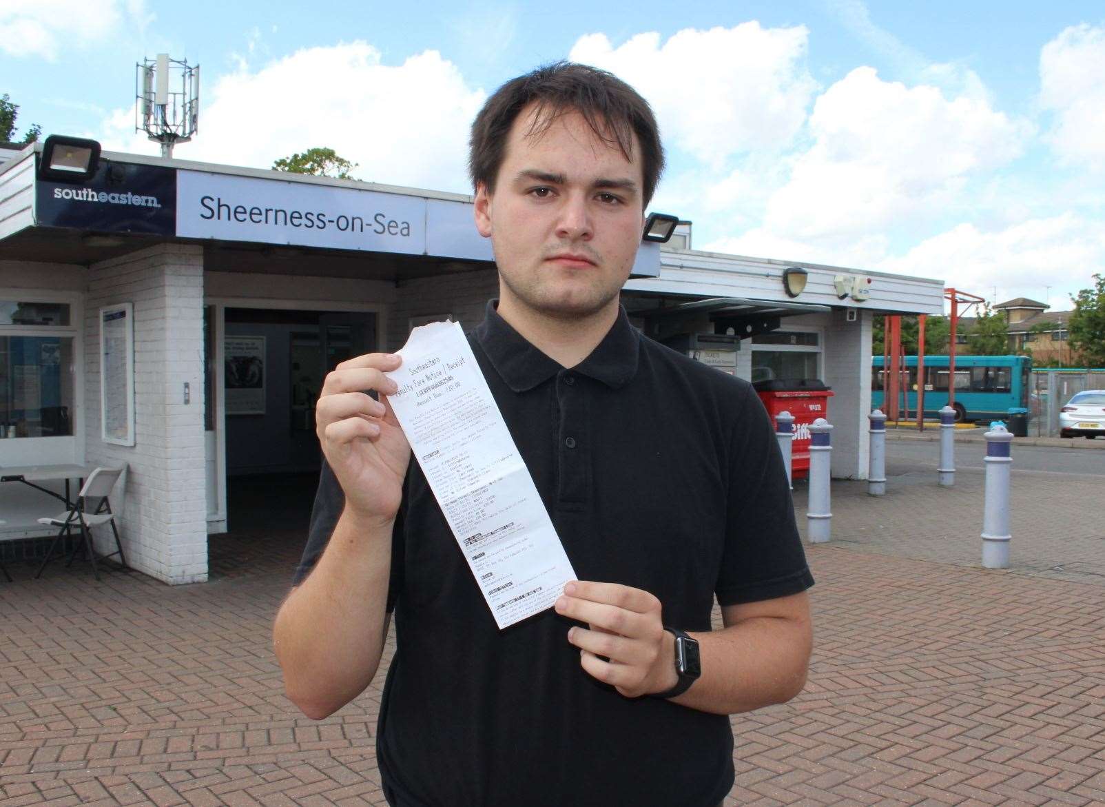 Oliver Edwards outside Sheerness train station with his £20 penalty notice