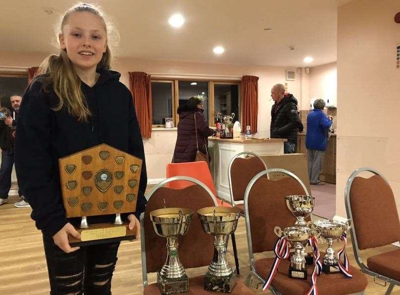 Lucy with some of her fishing trophies