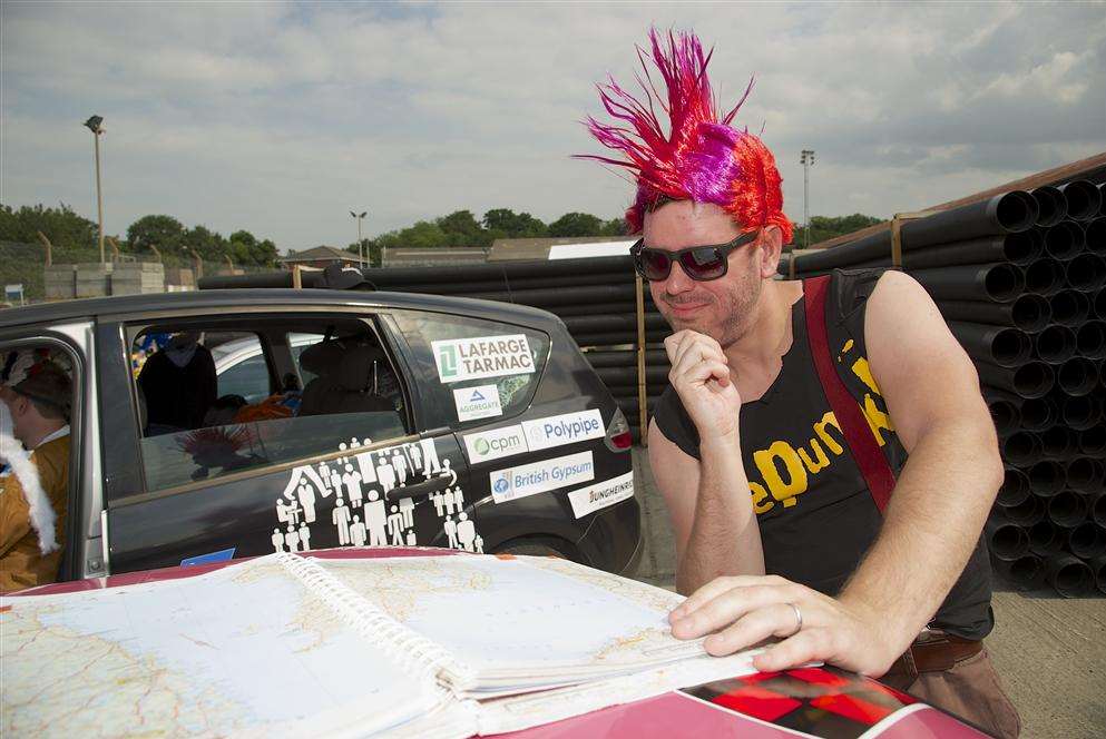 Matt Harris ponders routes on the top of a pink Mini.