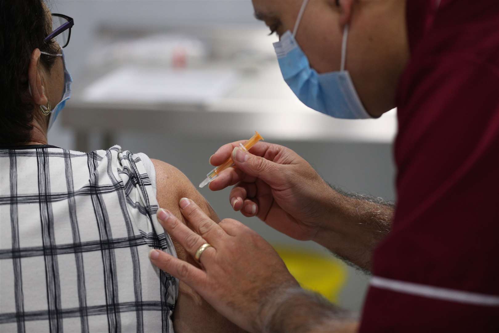 A person receives a dose of the Oxford/Astrazeneca coronavirus vaccine during a clinic at the Winter Gardens in Blackpool.