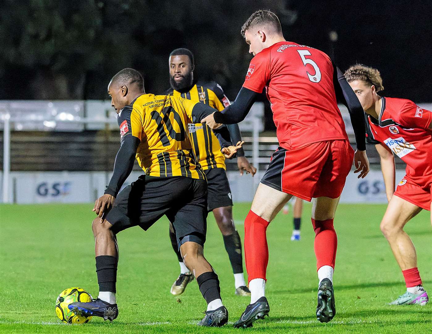 New signing Matthias Fanimo on the ball for Folkestone as Phoenix Sports defender Sam Huckle puts him under pressure. Picture: Helen Cooper