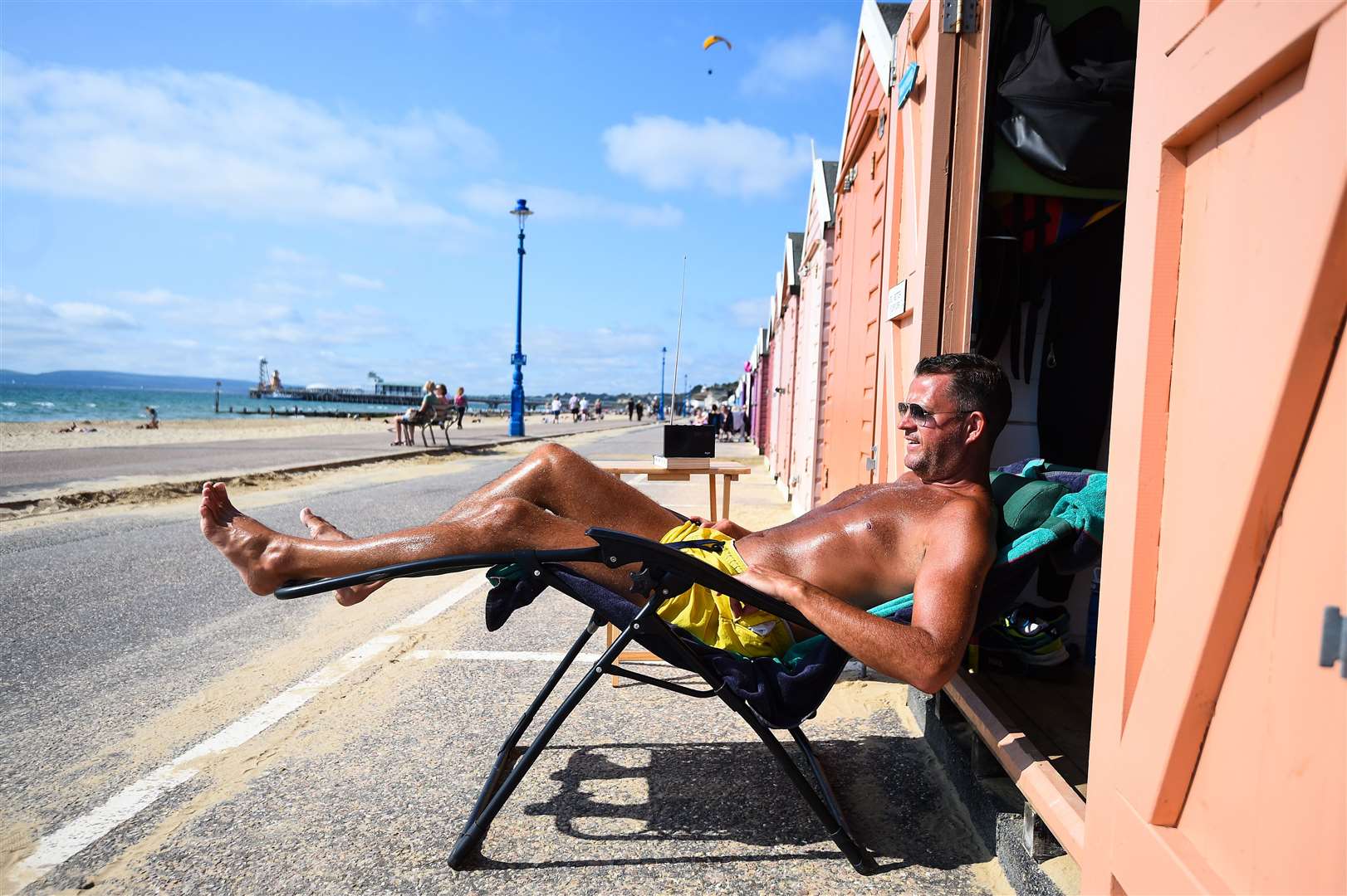 Stuart Henderson enjoys the Autumn sunshine from his beach hut in Bournemouth (Kirsty O’Connor/PA)