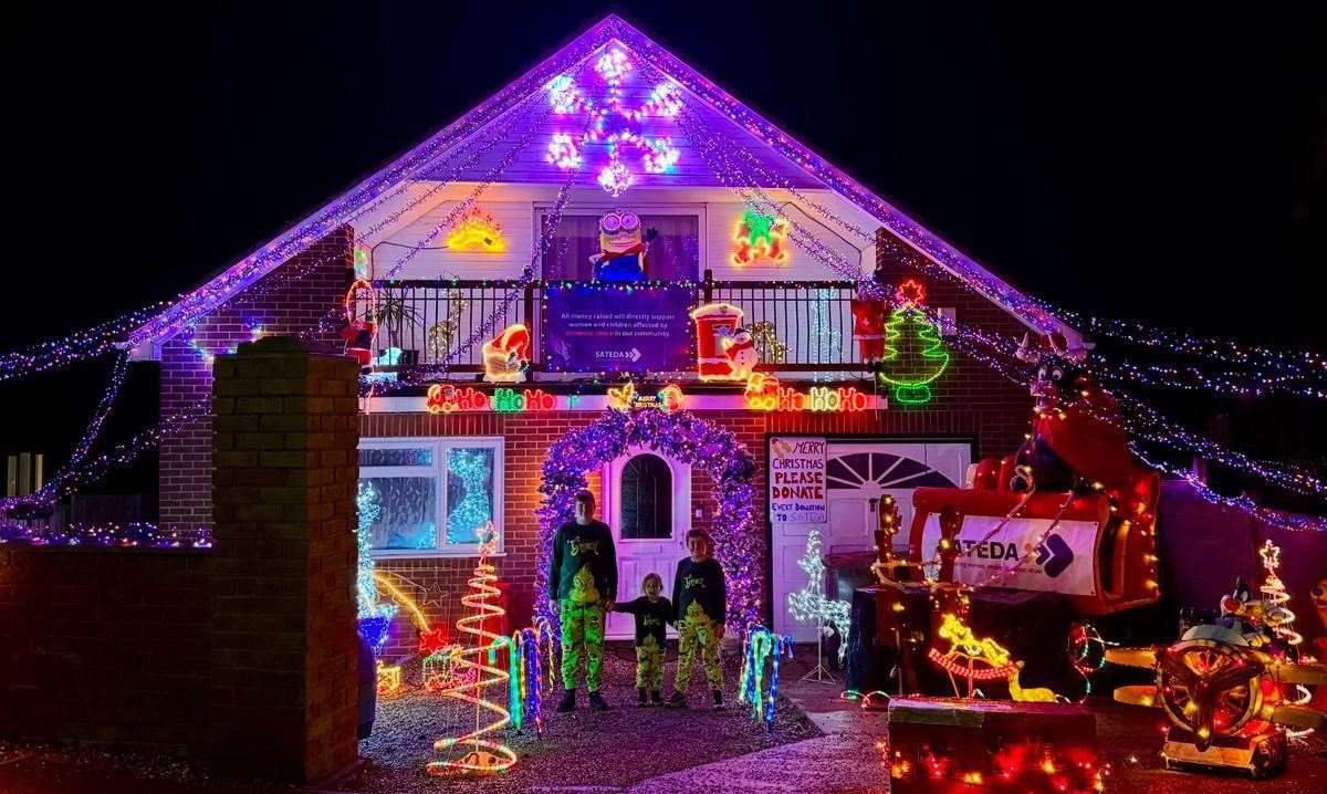 Jamie, 16, Paige, four, and Reece, eight, have put up hundreds of lights in Imperial Drive, Warden. Picture: SATEDA