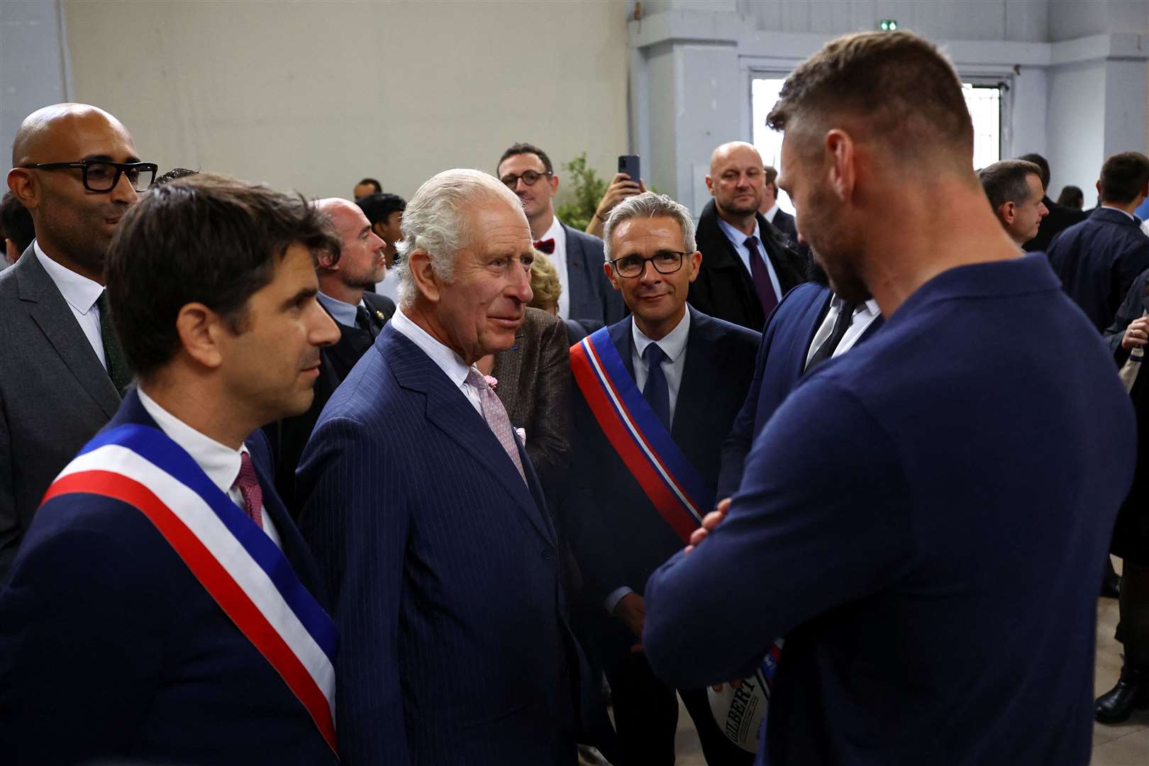 The King speaks to Welsh rugby player Dan Biggar (right) (Hannah McKay/PA)