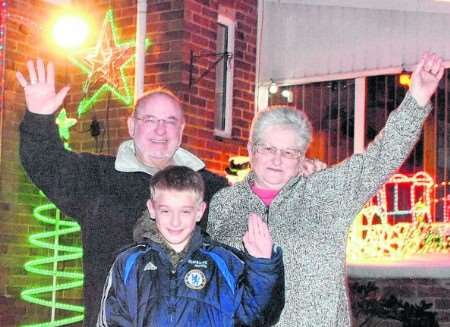Brian Gilbert, his wife Ann, and neighbour James Steel, 10, at this year's switch on.