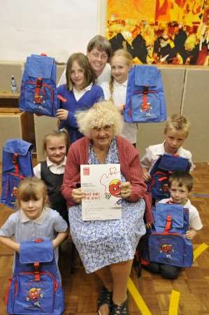 The six best fundraising Eastchurch School pupils and teacher Teresa Kincaid (top) with Joyce Fuller