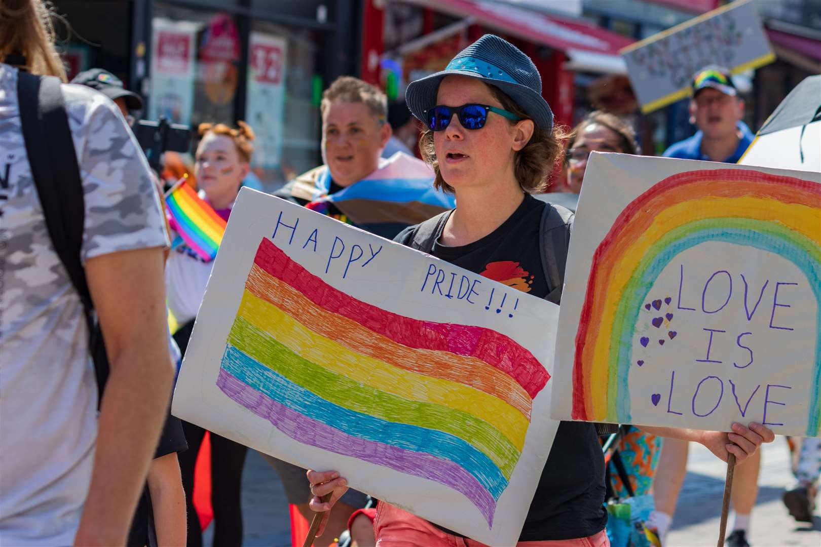 Attendees held flags and signs during the march. Picture: Ben Archell