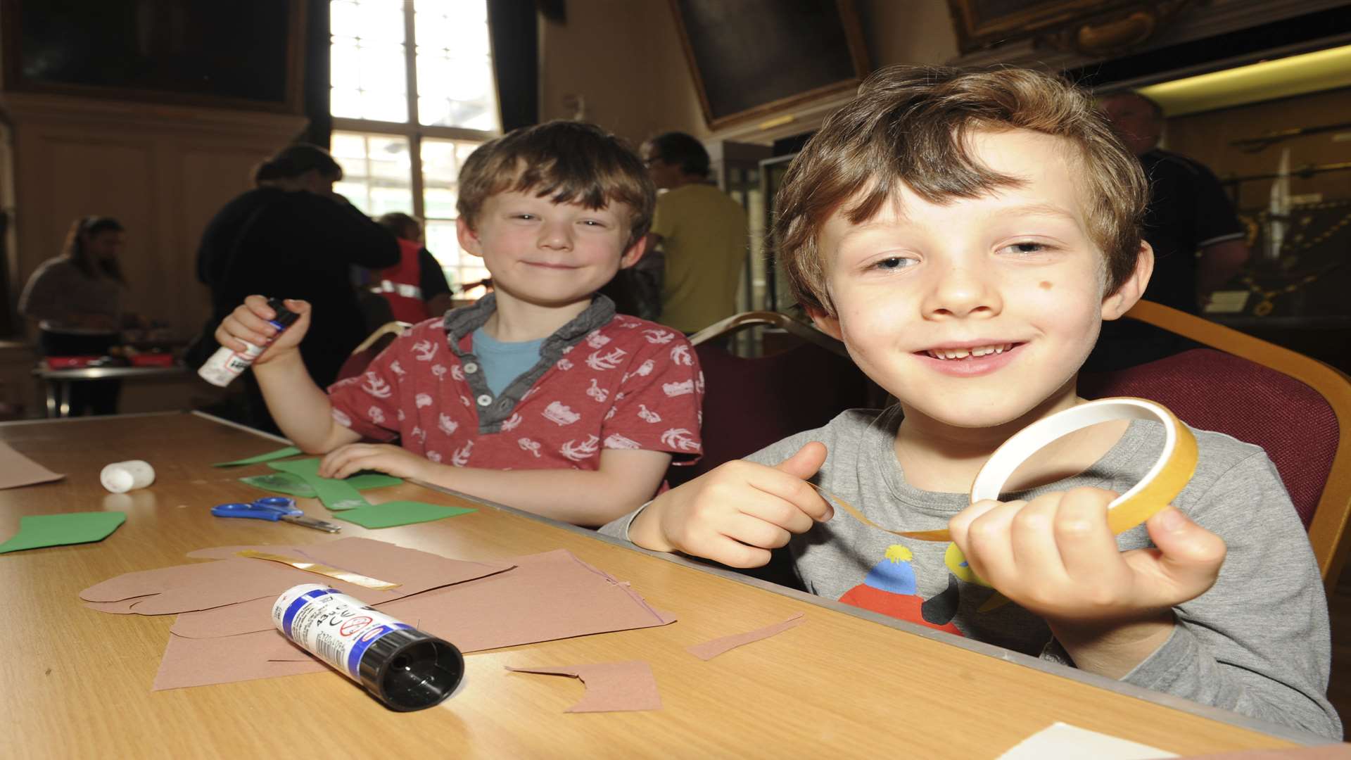 Twins, Marlowe and Huxley Hill, aged, five, get creative at a cave chic arts and crafts workshop at the Guildhall Museum