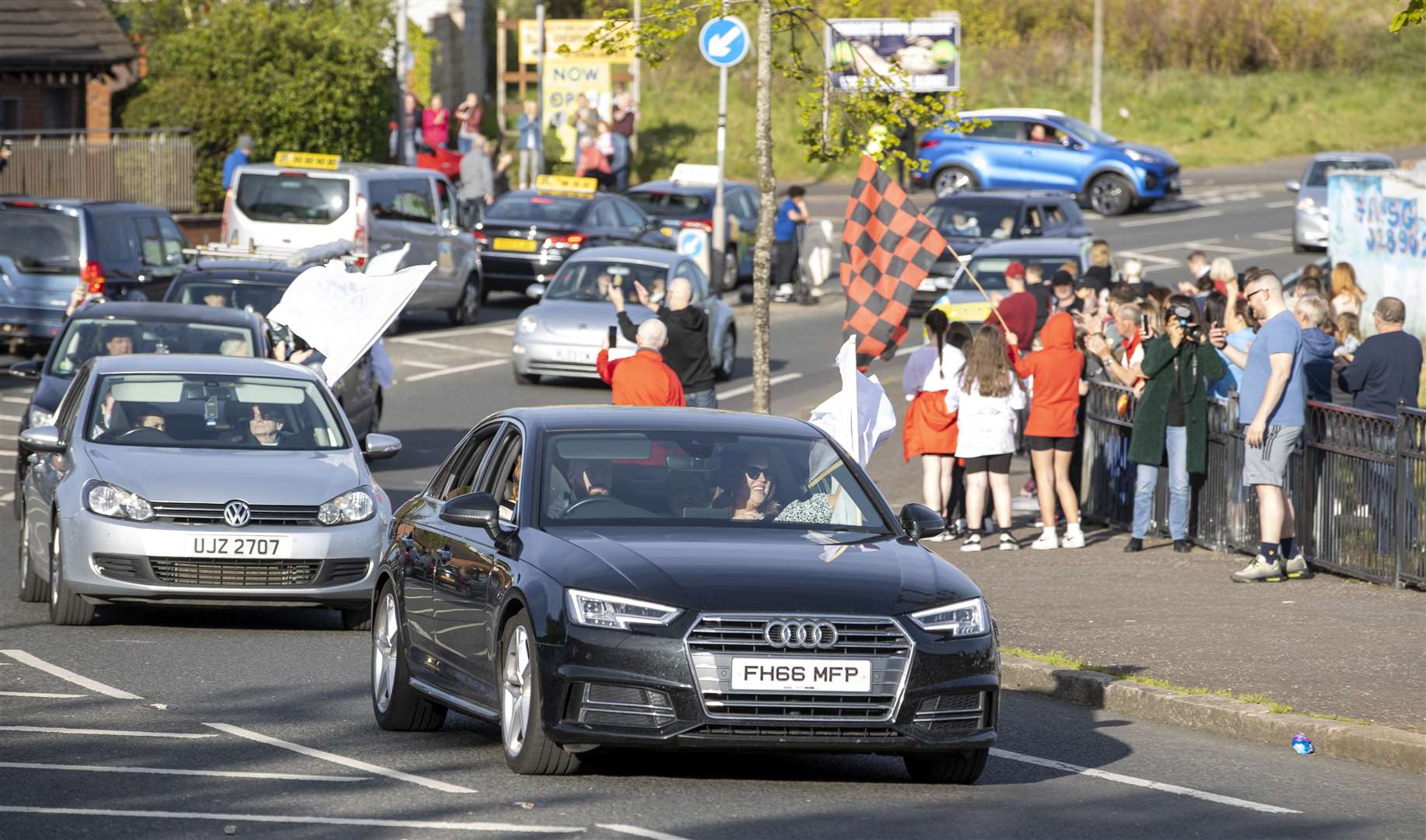 A cavalcade of cars passing through Ballymurphy, thanking the community for its support over the past 50 years (Liam McBurney/PA)