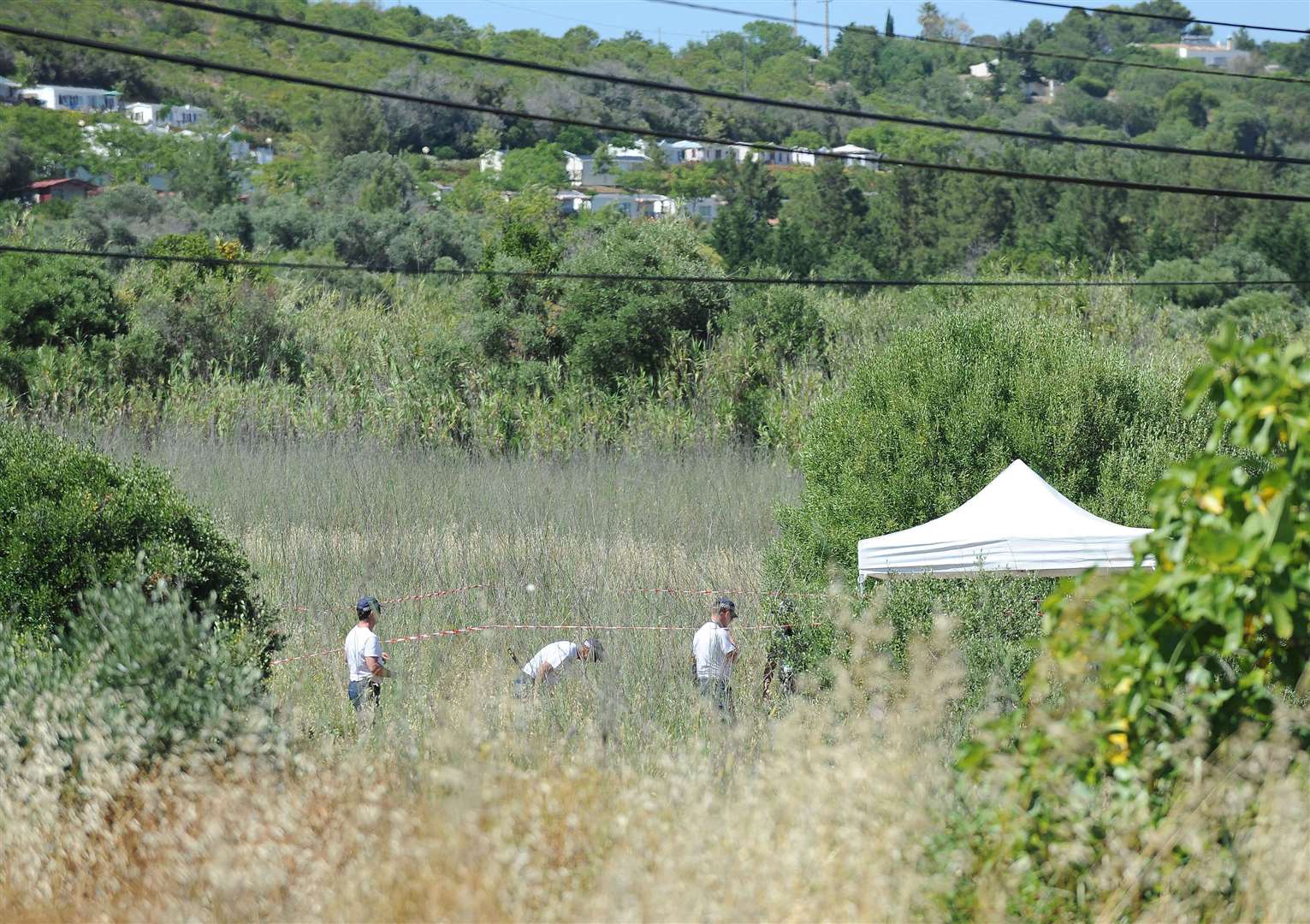 British police and their Portuguese counterparts investigating the disappearance of Madeleine McCann during a search of scrubland (Nick Ansell/PA)