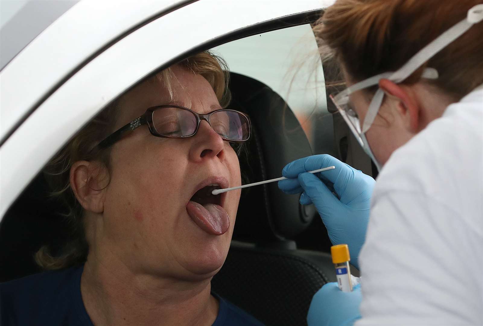 A test sample is taken at a Covid-19 testing centre at Glasgow Airport (Andrew Milligan/PA)