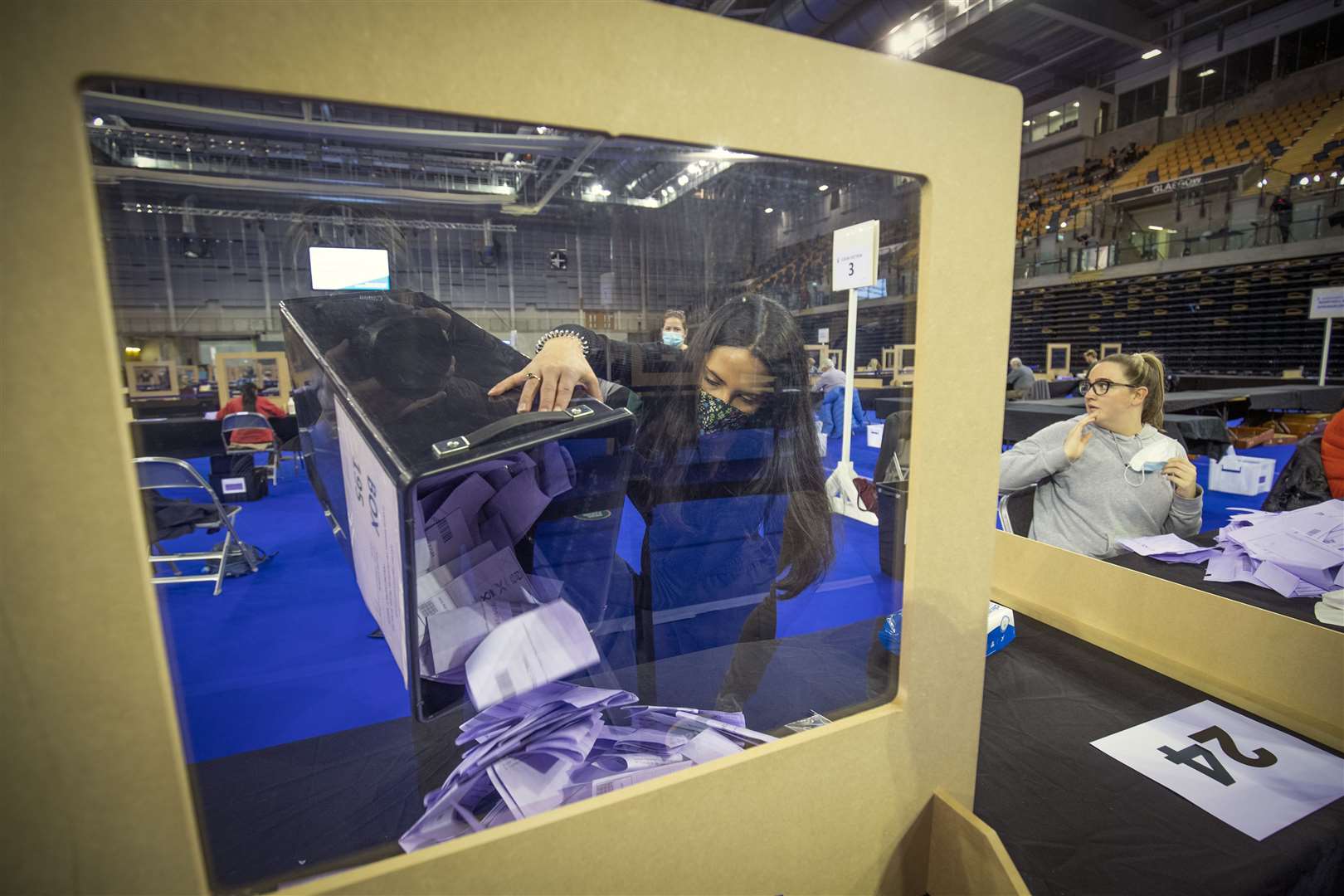 Votes are poured out of a ballot box at the Emirates Arena in Glasgow ready for counting (Jane Barlow/PA)