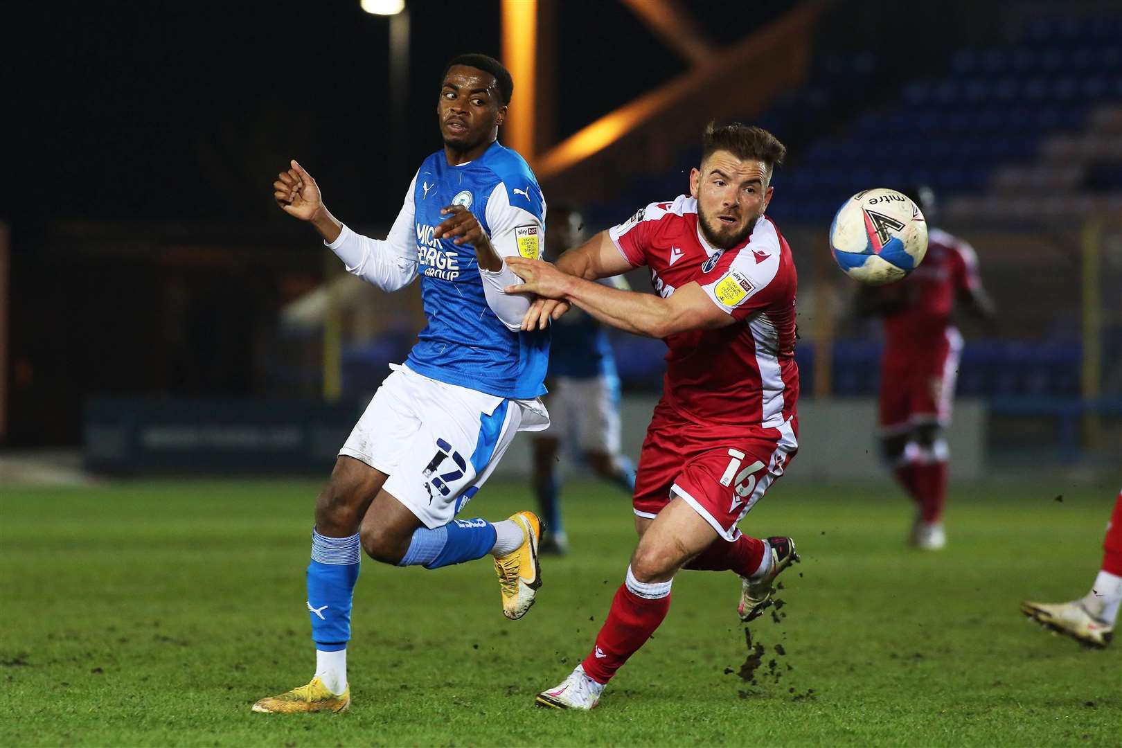 Reece Brown of Peterborough United in action with Gillingham's Alex MacDonald Picture: Joe Dent/JMP