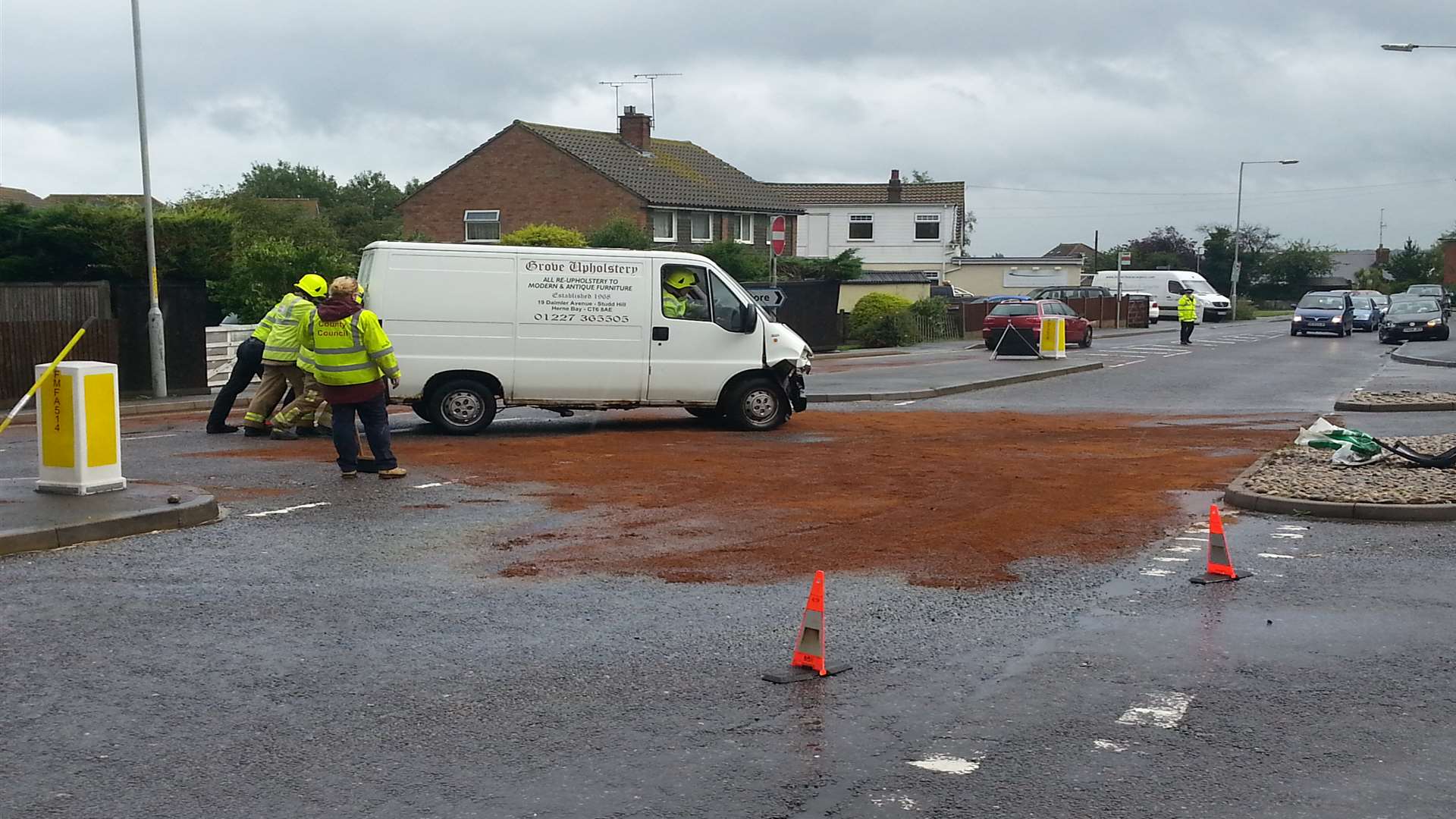 The van being removed from the road by firefighters