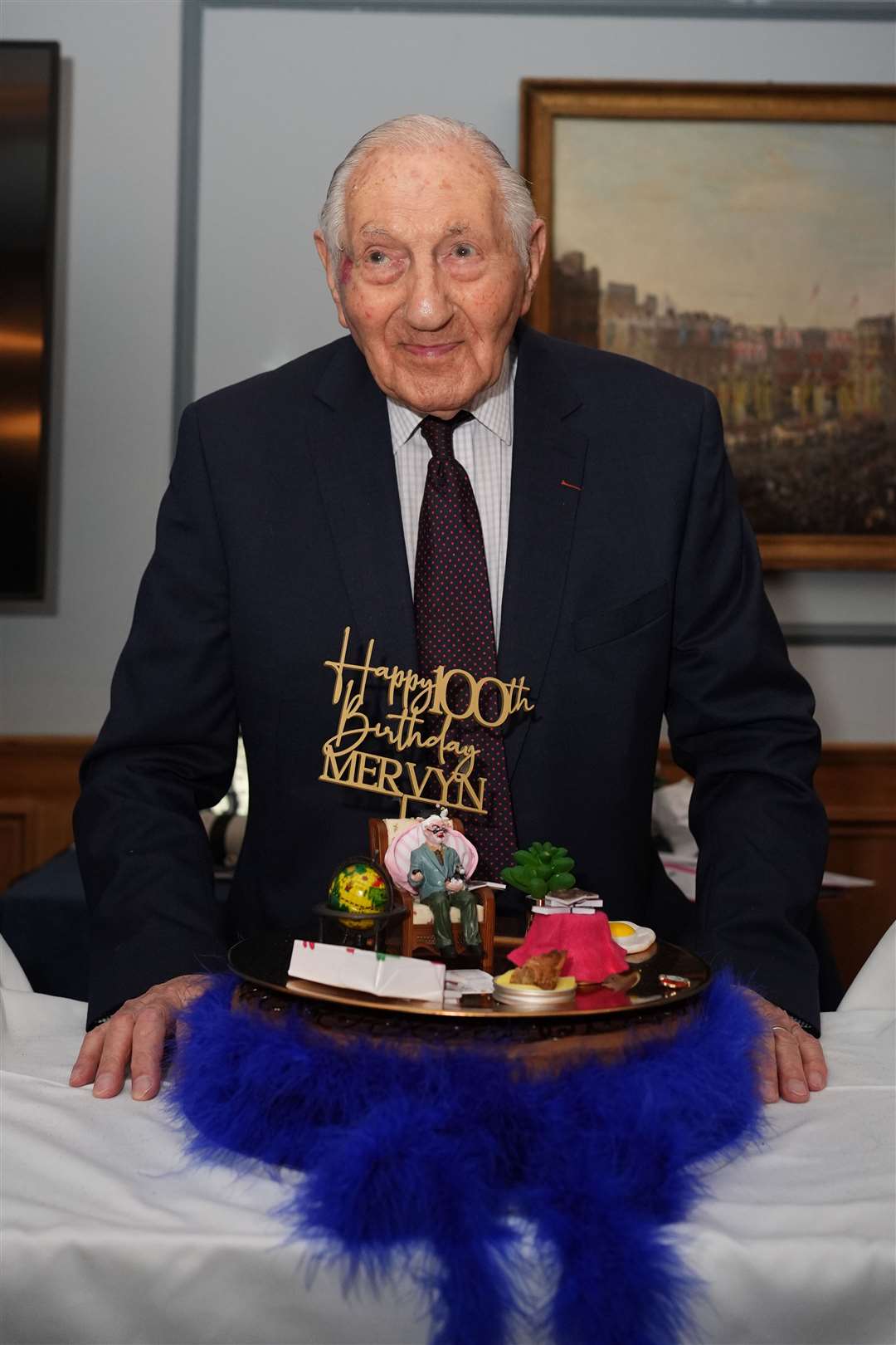 Mervyn Kersh with his cake during a surprise party for his 100th birthday at the Union Jack Club in London (Jordan Pettitt/PA)