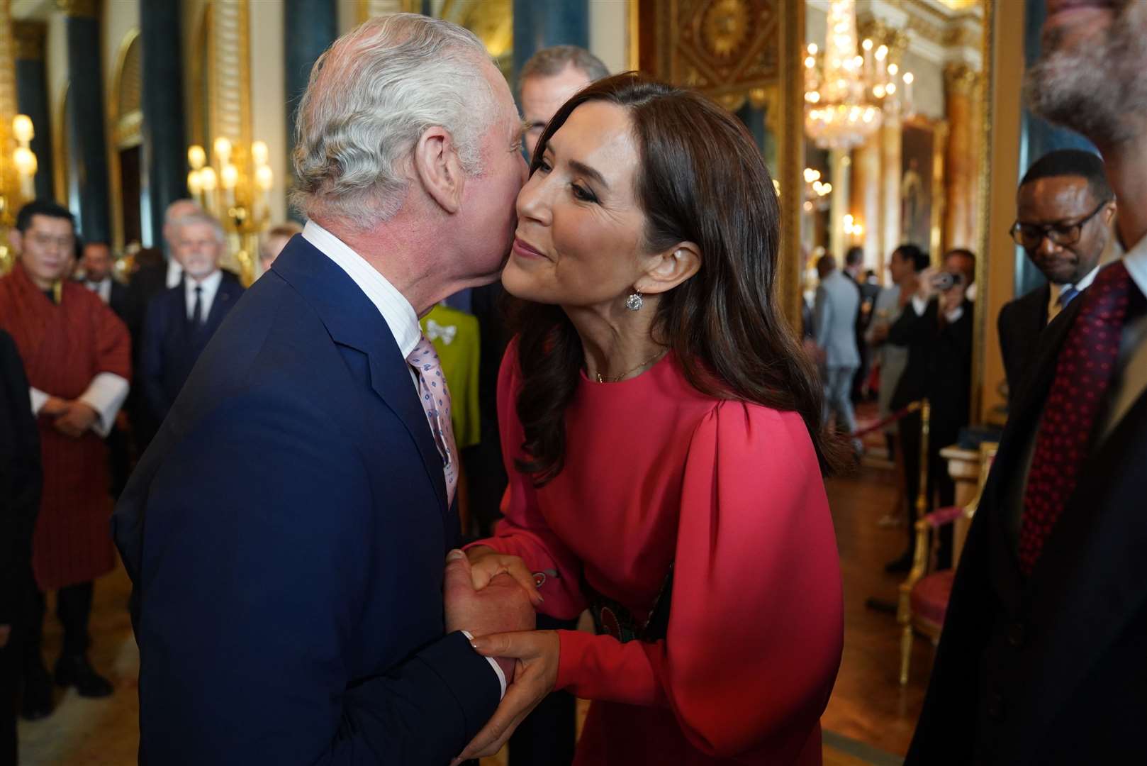 The King greets Mary, Crown Princess of Denmark, during a reception at Buckingham Palace (Jacob King/PA) 